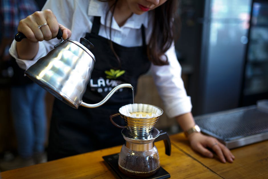 Coffee being brewed using pour-over method with fresh grounds.